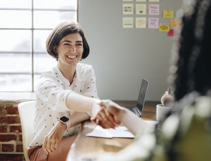 Happy businesswomen doing a handshake