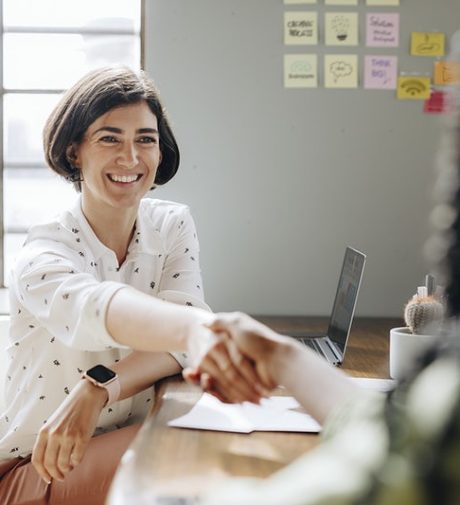 Happy businesswomen doing a handshake